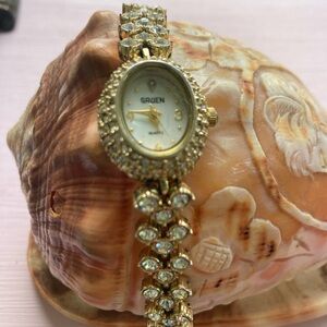 Gold and White Vintage-Style Watch with Crystal Accents